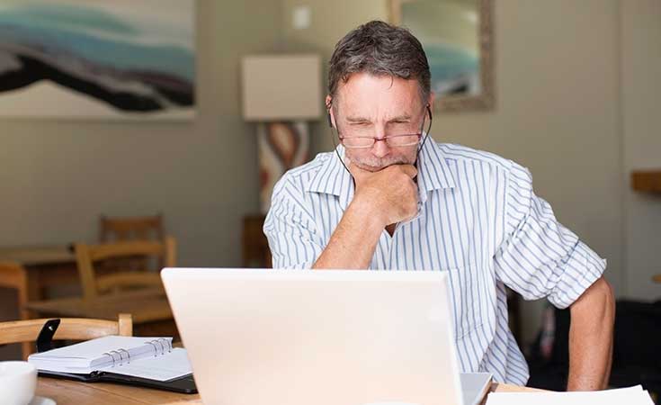 man sitting working at laptop