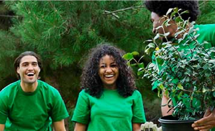 three young people laughing outside while gardening